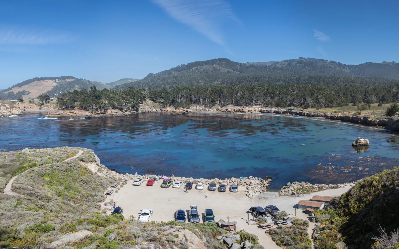 Whaler's Cove at Point Lobos with turquoise ocean water, rocky cliffs, and Monterey Cypress trees overlooking the Pacific
